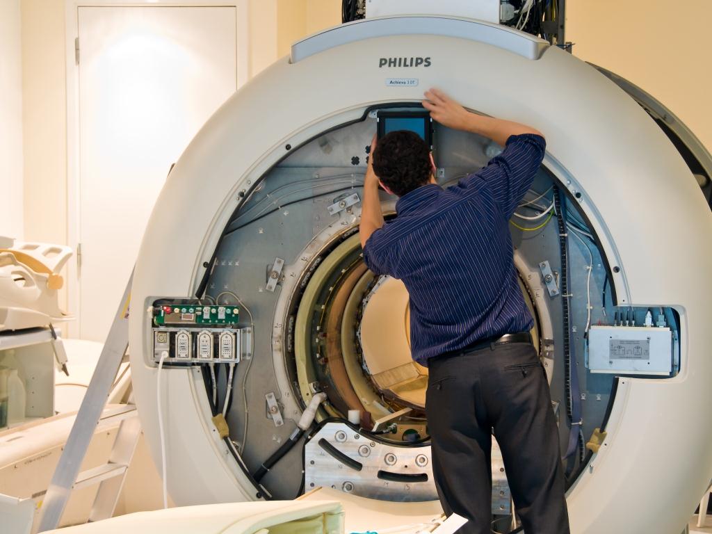 Technician repairing X-ray imaging equipment